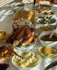 a table full of food including turkey, mashed potatoes and other condiments