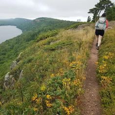 a person walking up a hill with a backpack