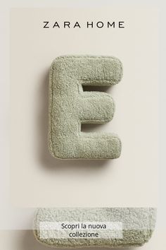 the letter e is made out of towels and sits in front of a white wall