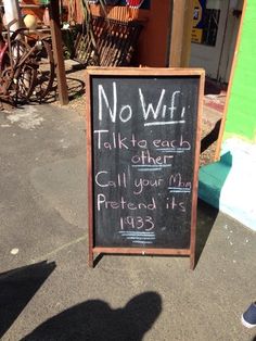 a chalkboard sign that says no wifi talk to each other call your mom pretend it 1933