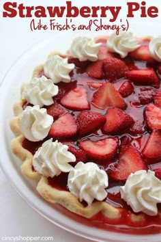 a strawberry pie on a white plate with whipped cream and strawberries in the middle