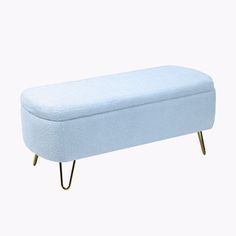 a light blue bench sitting on top of a white floor