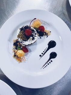 a white plate topped with two desserts covered in toppings