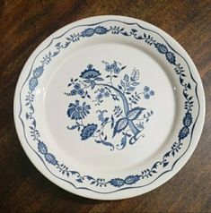 a blue and white plate sitting on top of a wooden table