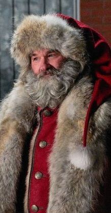 a man wearing a red coat and fur hat