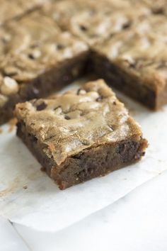 chocolate chip cookie bars cut into squares on parchment paper