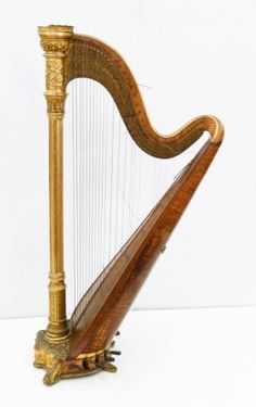 an old wooden and gold colored harp on a white background with clippings to the side