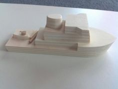 a wooden model of a boat on a table