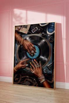 two hands touching each other on top of a vinyl record in front of a pink wall