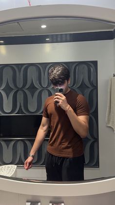 a man is taking a selfie in front of a mirror with his cell phone