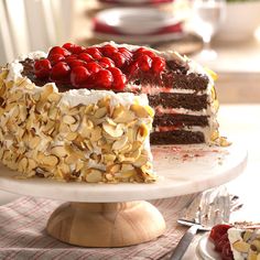 a cake with nuts and cherries on it