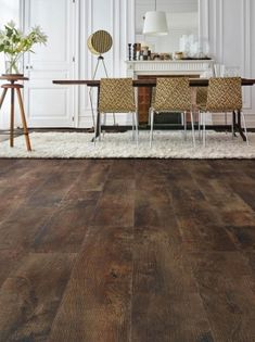 a dining room with wooden floors and white walls