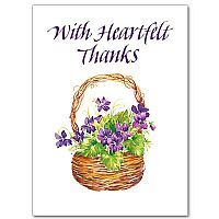 a greeting card with purple flowers in a basket and the words, with heartfelt thanks