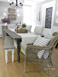 a dining room table with chairs and a chalkboard on the wall behind it that says doucette design has the most gorgeous dining room