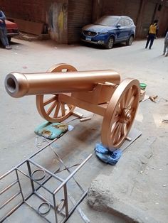 a large metal cannon sitting on top of a sidewalk