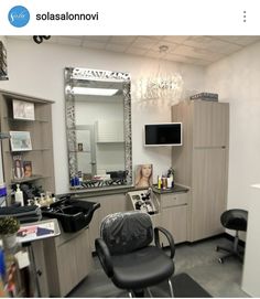 a hair salon with chairs and mirrors in it