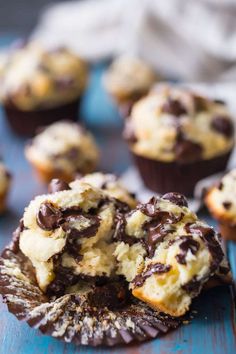 chocolate chip muffins are sitting on a blue surface