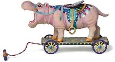 an elephant is pulling a toy carriage