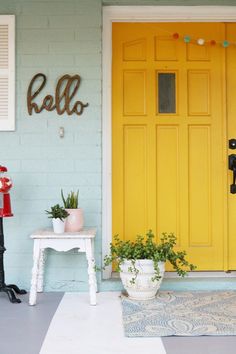 a yellow front door with the word hello written on it