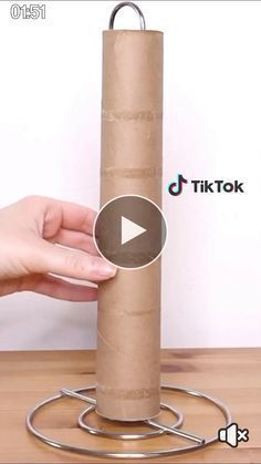 a person holding a roll of toilet paper on top of a metal holder with the word tiktok