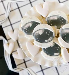 some cookies are arranged in the shape of hearts on a white plate with black and white designs