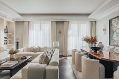 a living room filled with lots of white furniture