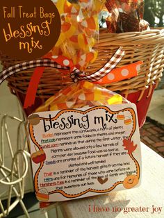 a basket filled with lots of candy sitting on top of a table next to a sign that says blessing mix