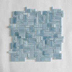 a piece of blue glass mosaic tile on a white background