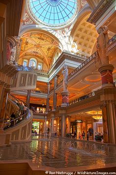 the inside of a shopping mall with people walking around