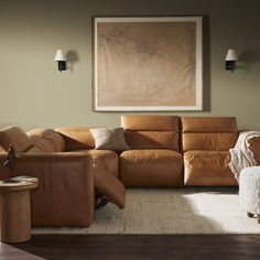 a living room filled with furniture and a painting on the wall