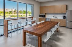 an empty kitchen and dining room with large windows