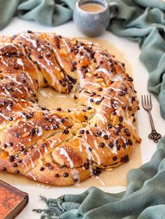 a pastry with chocolate chips and icing sitting on top of a table