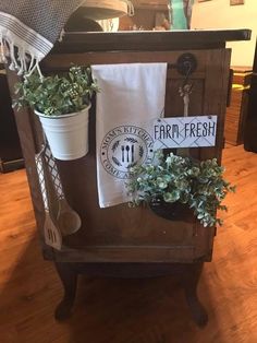 a potted plant sitting on top of a wooden table next to a tea towel