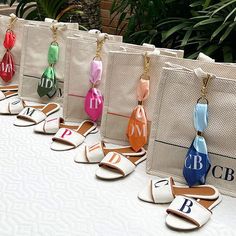 the bags are lined up on the table to be used as keychains for purses