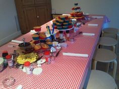 a table topped with lots of cupcakes and other desserts on top of it