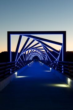 an illuminated walkway leading into the distance