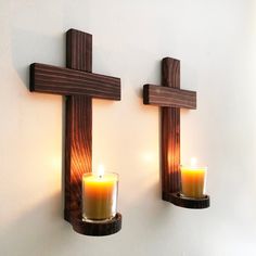 two cross shaped candles are on the wall