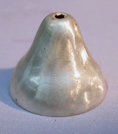 a silver object sitting on top of a white surface