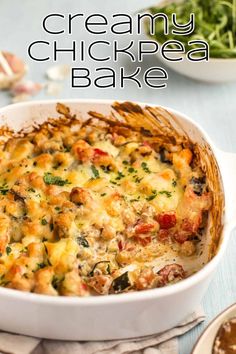 a casserole dish with chicken and cheese in it on a blue tablecloth