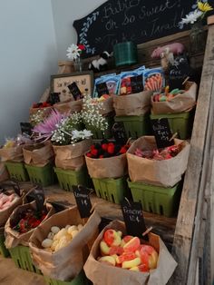 several baskets filled with different types of fruit on display in front of a chalkboard