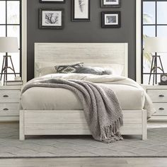 a bedroom with gray walls and white furniture