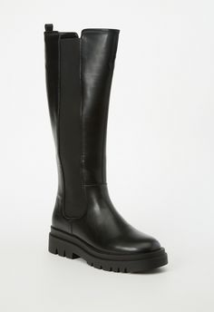 A flat boot with a lug sole and zip closure. Black Boots Flat, Shoes For Winter, Knee High Black Boots, Fall Nyc, High Black Boots, Black Flat Boots, Wide Width Boots, Fashion Shoes Boots, Competition Costumes