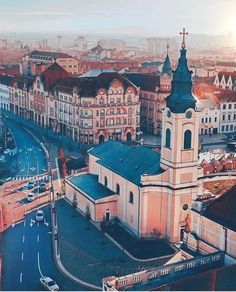 an aerial view of a city with tall buildings and a cross on the top of it