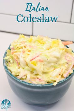 a blue bowl filled with coleslaw on top of a white counter