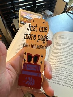 someone is holding up a bookmark that reads just one more page let's tell material