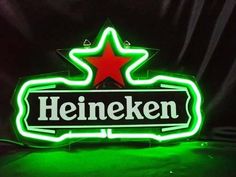 a neon sign that says heineken with a red star on the top and green bottom