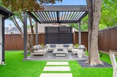 an outdoor living area with grass and trees