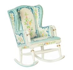 a white rocking chair with blue and green fabric