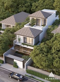 an aerial view of a two story house surrounded by trees