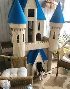 a black and white cat standing in front of a castle made out of legos